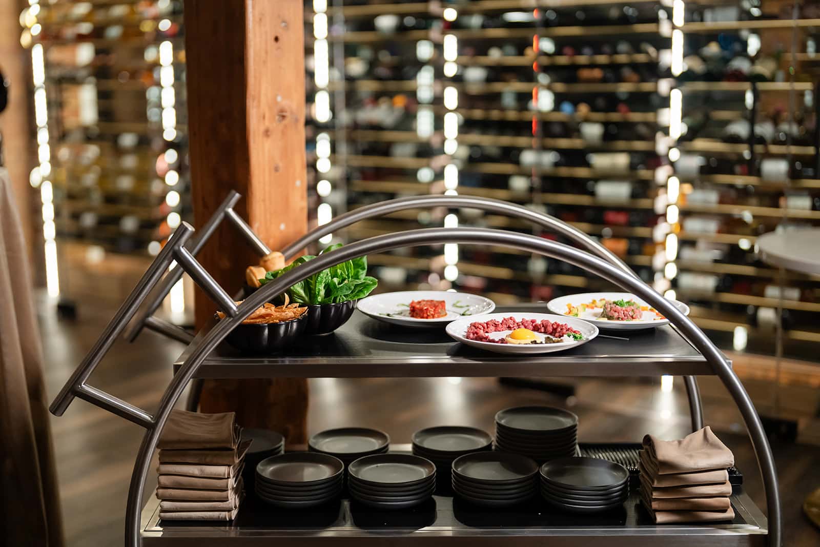 silver tartare catering cart and wine wall